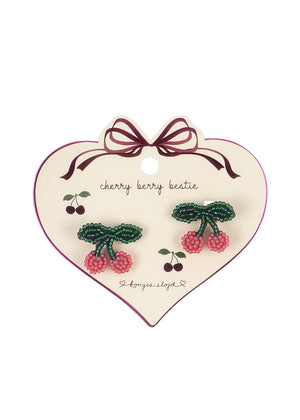 Pearly cherry hair clips on heart-shaped card, perfect for festive occasions or adding charm to everyday hairstyles.