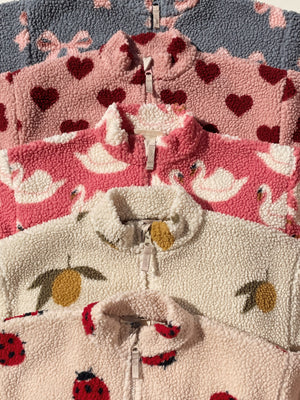 Colorful Jody Teddyjacke collection featuring heart, swan, lemon, and ladybug designs in soft fleece material.