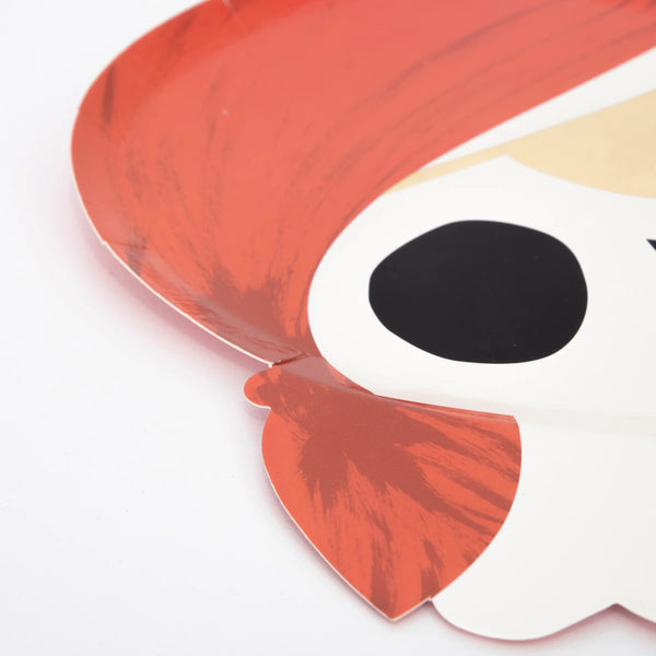 Close-up of a brightly colored pirate party plate featuring a skull with a red bandana from Meri Meri.