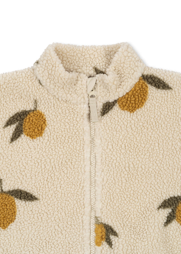 Close-up of Jody Teddyjacke, featuring cream teddy fabric with lemon print and a high collar zip.